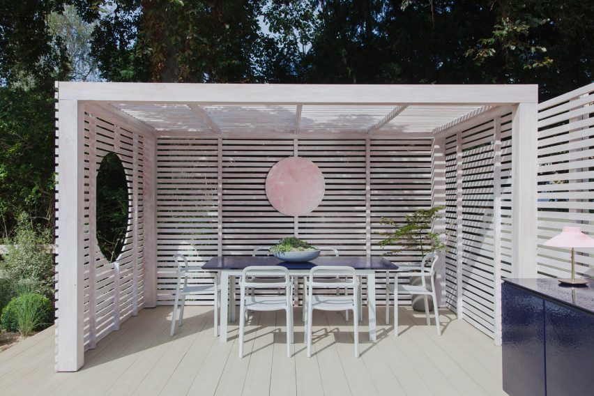 White-painted garden pavilion with dining area