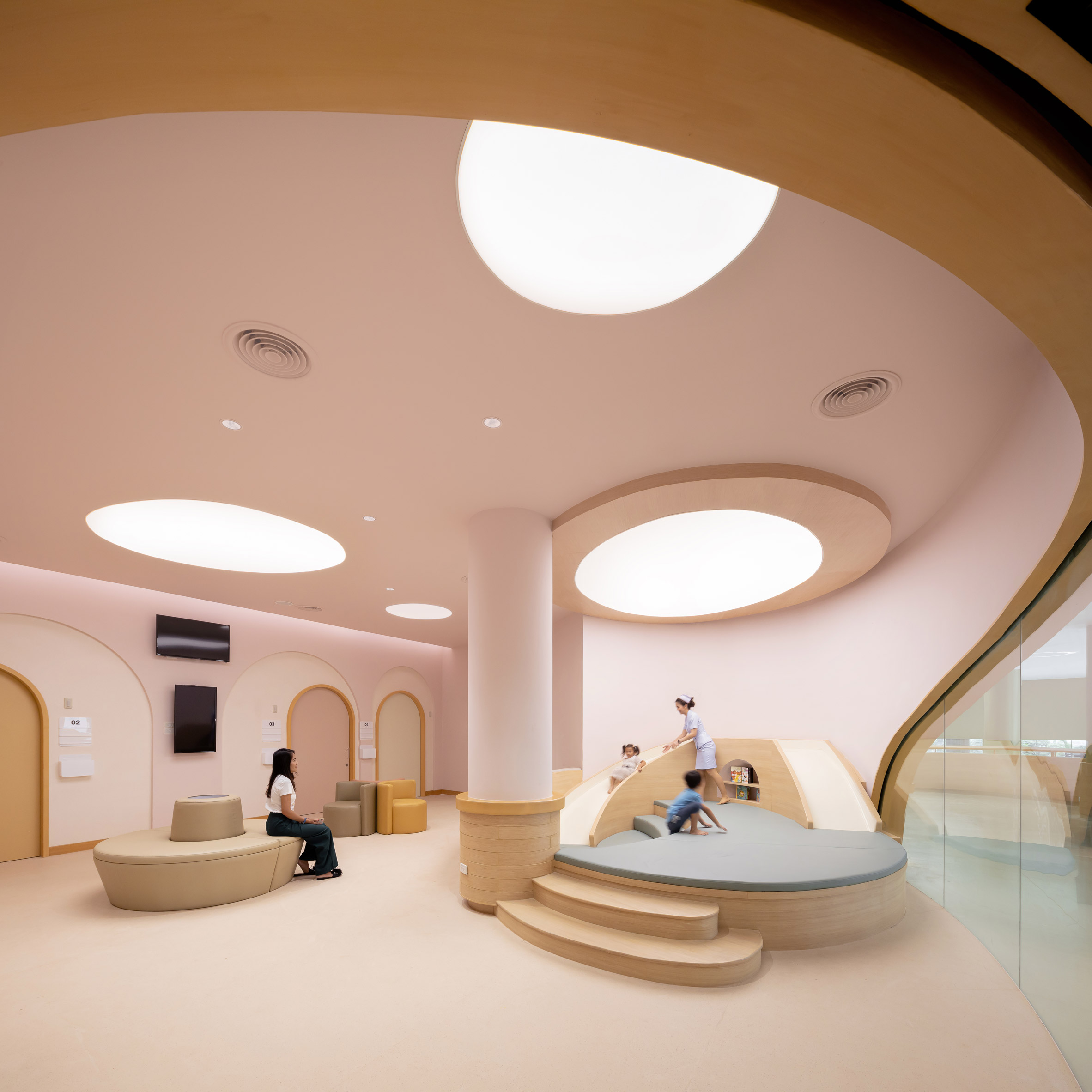 Curving pink play area in children's hospital by Integrated Field