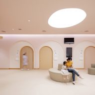 Arches and curved seating in children's hospital by Integrated Field