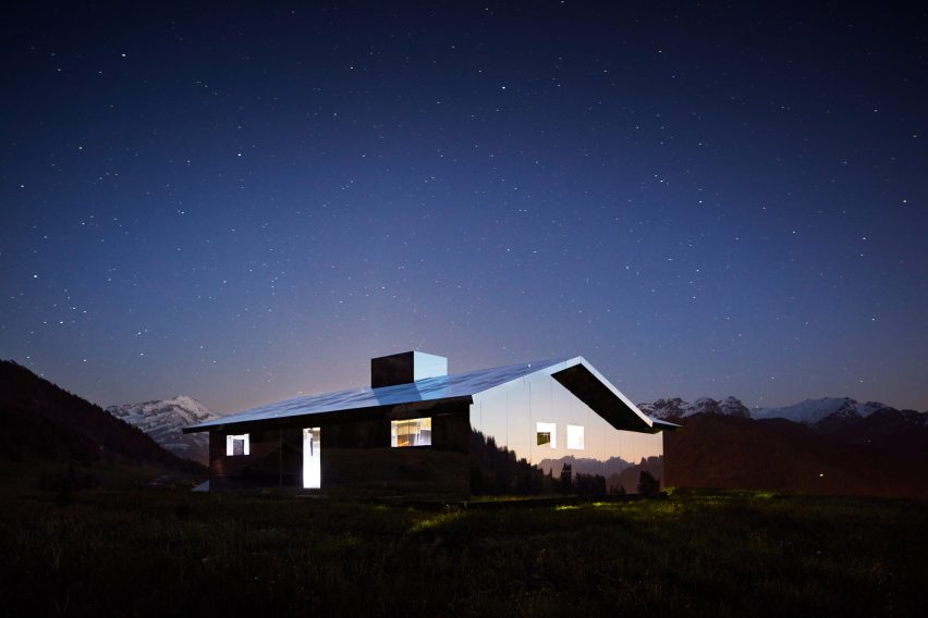 Mirage Gstaad mirrored building art installation by Doug Aitken in Switzerland at night