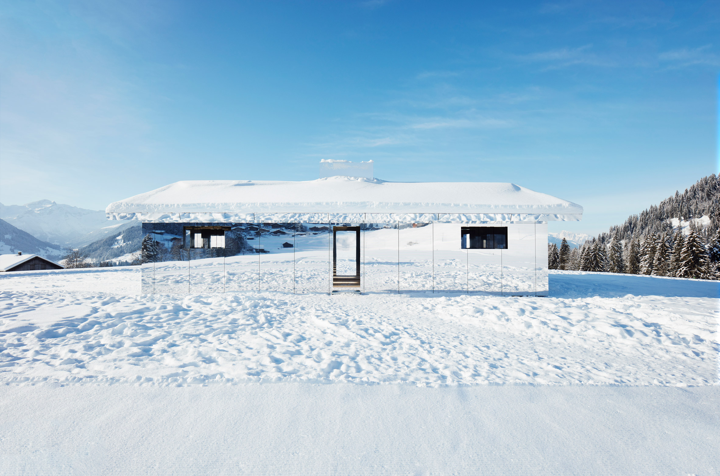 Mirage Gstaad mirrored building art installation by Doug Aitken in Switzerland in winter