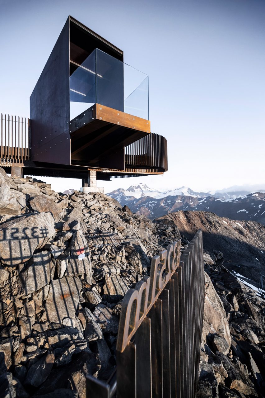 Viewing platform made of weathering steel and glass projects over Italian Alps