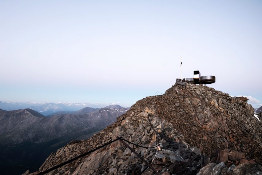 Viewing platform overlooks glacier on top of mountain ridge in South Tyrol