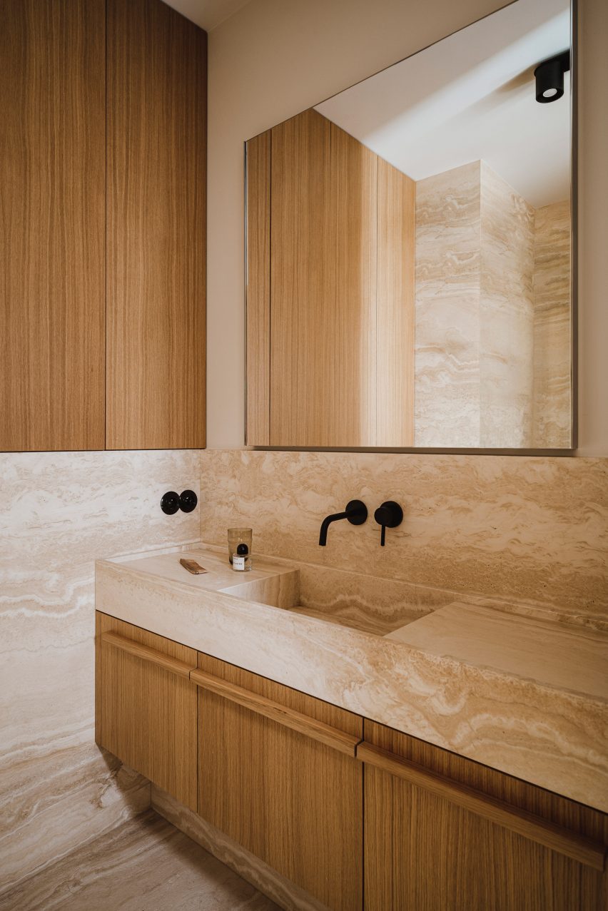 Travertine marble bathroom of Botaniczna Apartment by Agnieszka Owsiany Studio