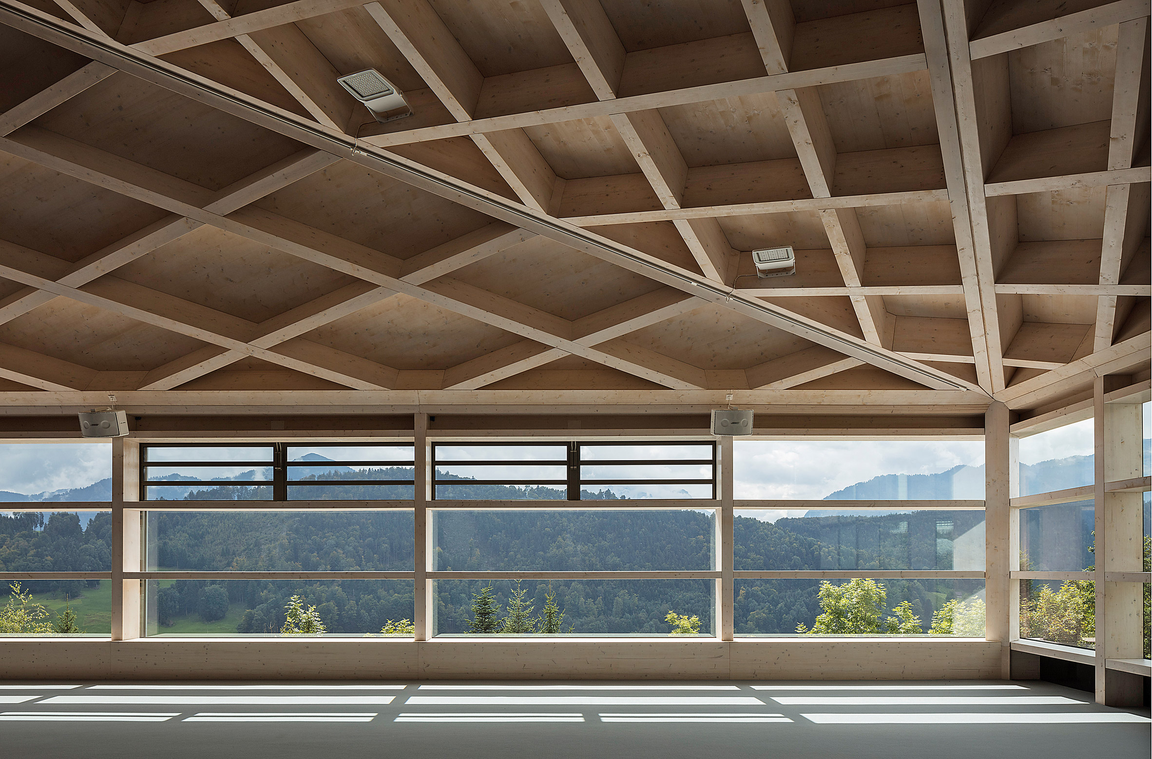 Windows of Diamond Domes tennis courts designed by Rüssli Architekten with CLT roofs by Neue Holzbau in the Swiss Alps
