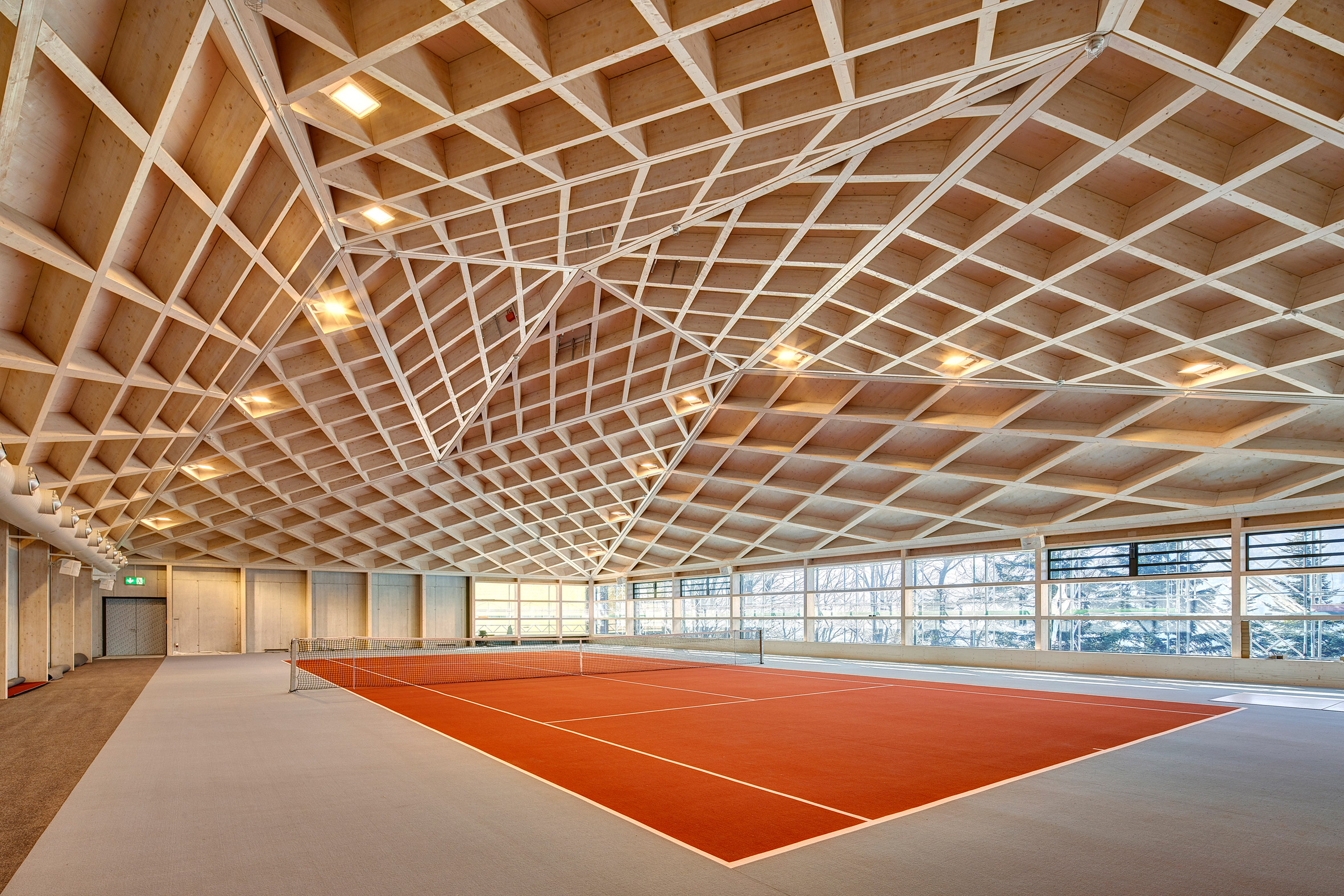 Interior of Diamond Domes tennis courts designed by Rüssli Architekten with CLT roofs by Neue Holzbau in the Swiss Alps