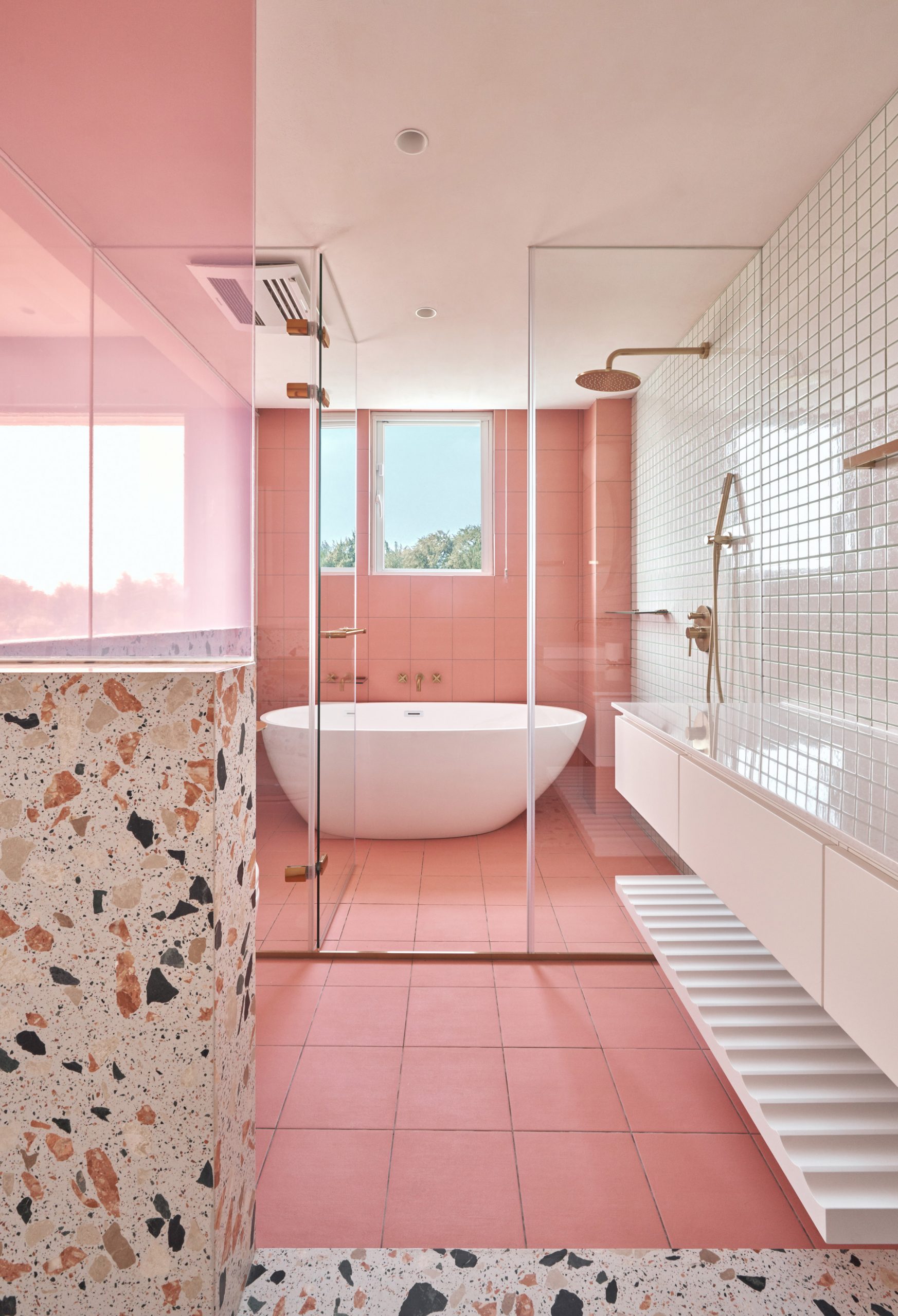 A bathroom with pink tile