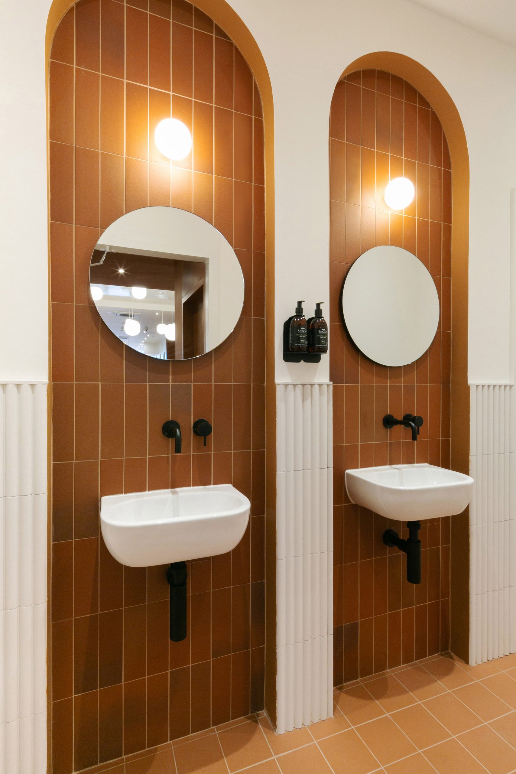 Bathrooms inside Beam cafe in London feature terracotta tiles