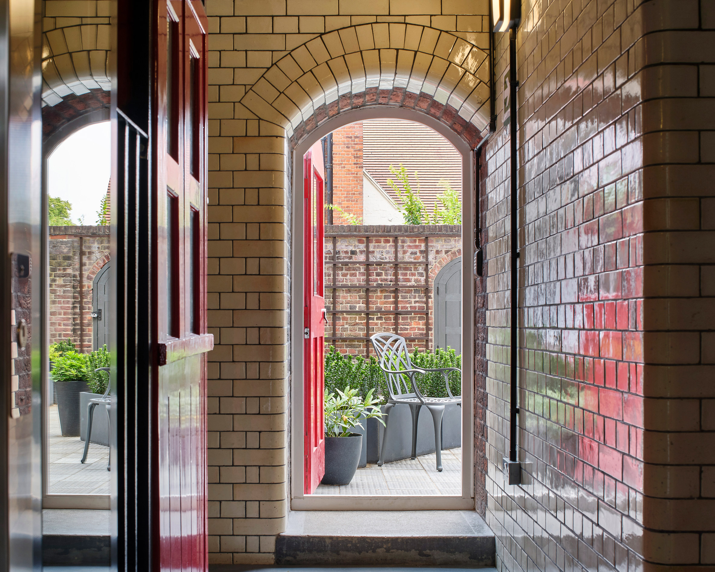 Arched brick doorway of Belsize Fire Station apartments by Tate Harmer, London