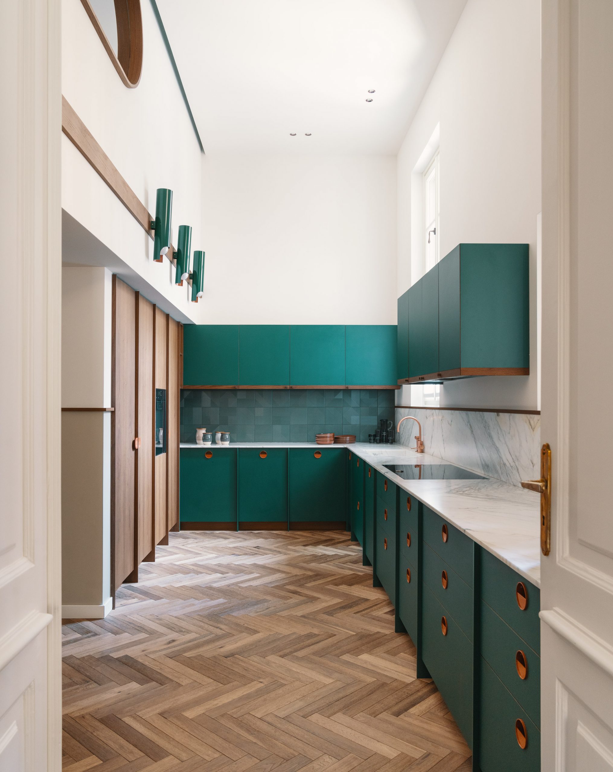 Teal kitchen counter with copper handles