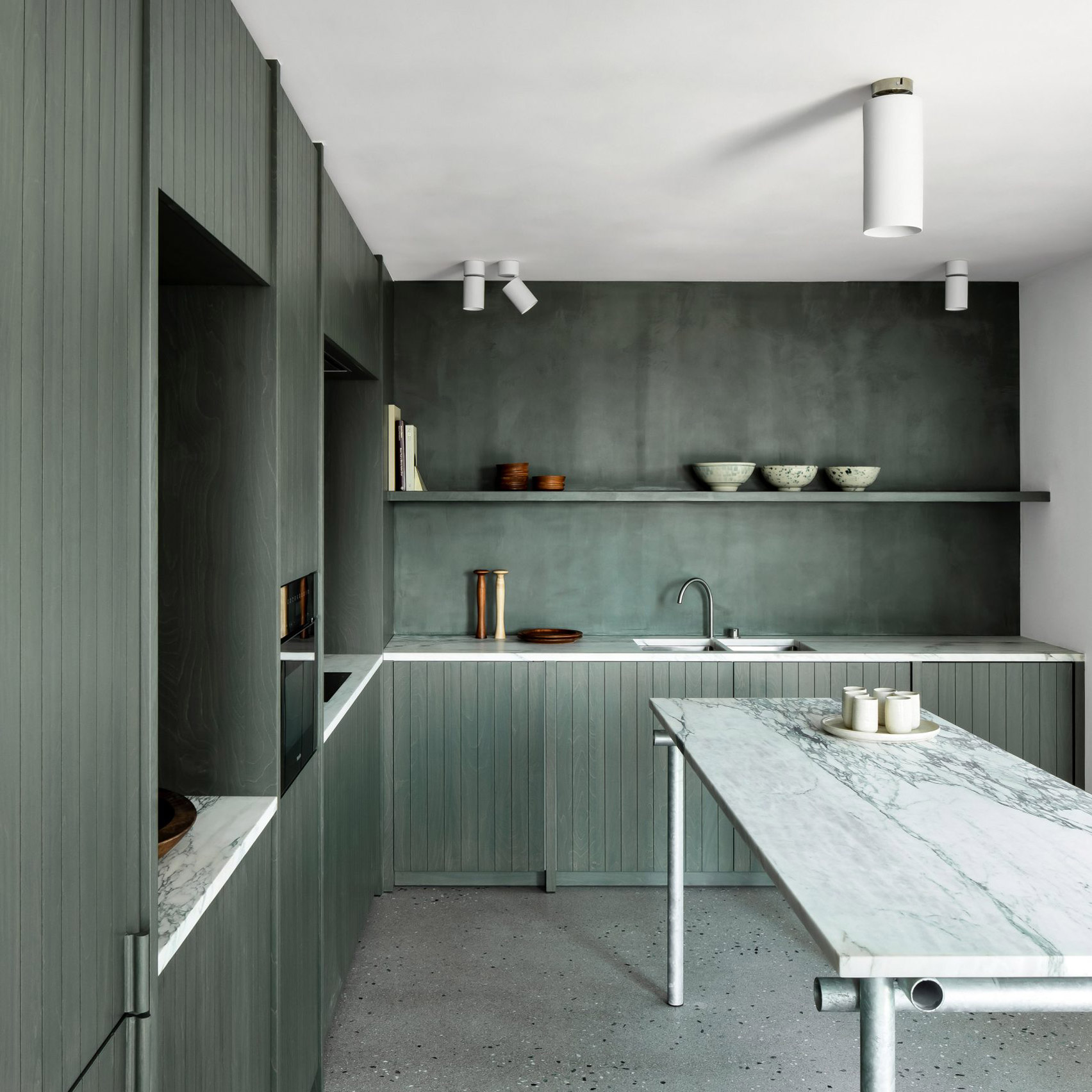 Seaweed-coloured kitchen with marble worktops