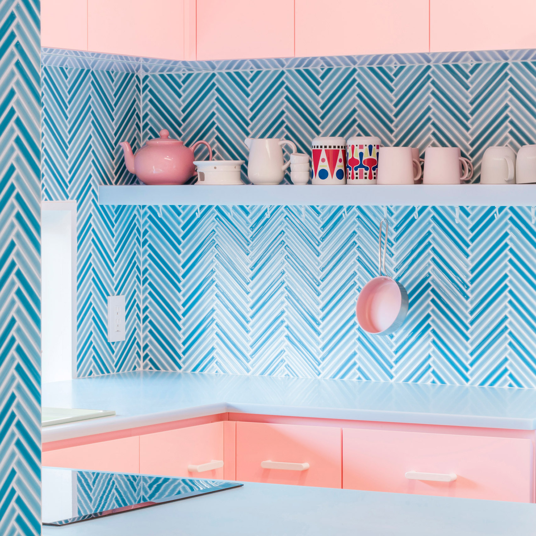 Bubblegum-pink kitchen with parquet blue tiles
