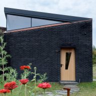 Textured black brick props up "beak-like" windows in Dutchess County Studio