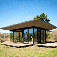 Olson Kundig designs glass cabin with drawbridge-style shutters