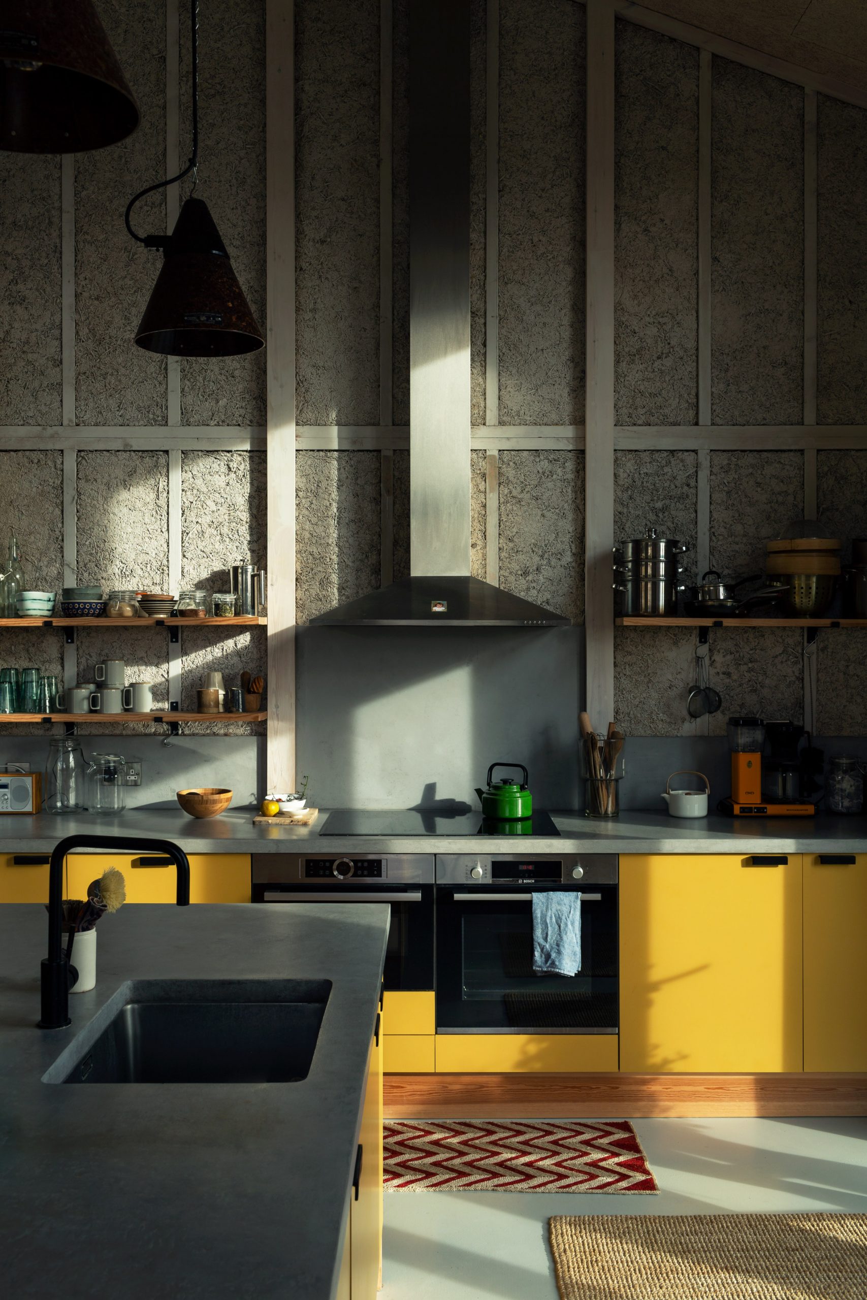 Kitchen with hemp walls and yellow cupboards