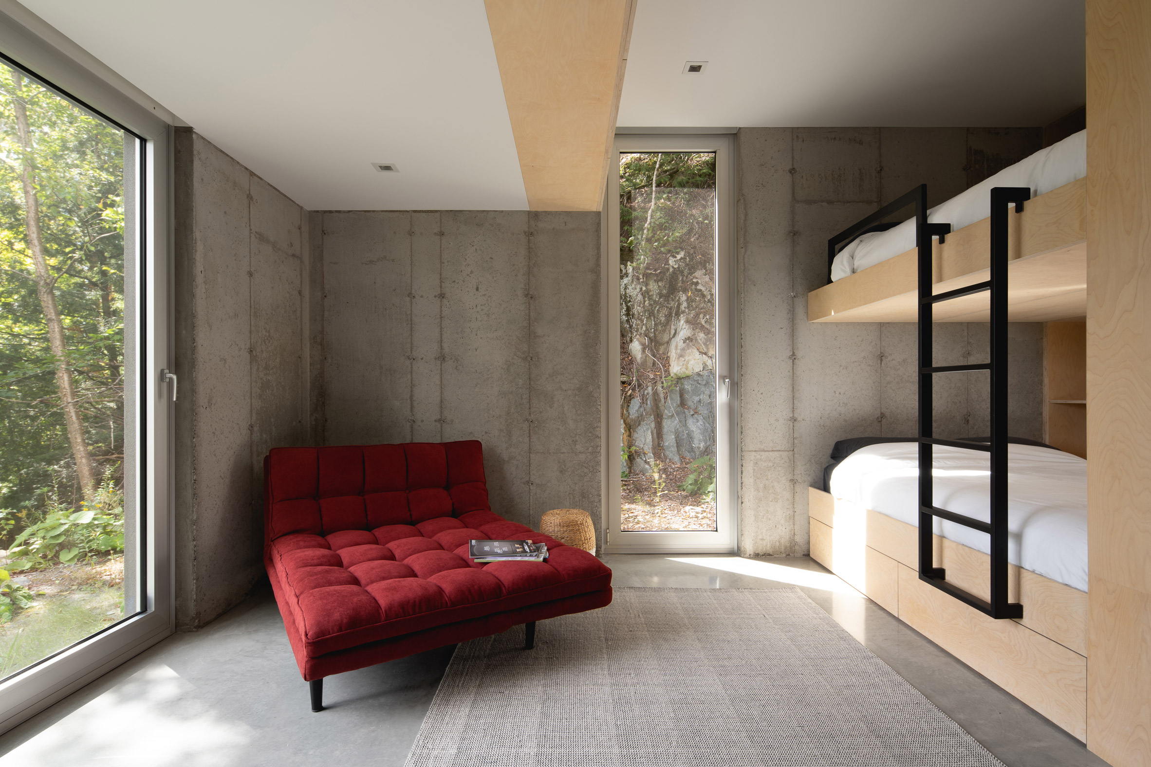 Sofa in bunk room of Forest House I by Natalie Dionne Architecture