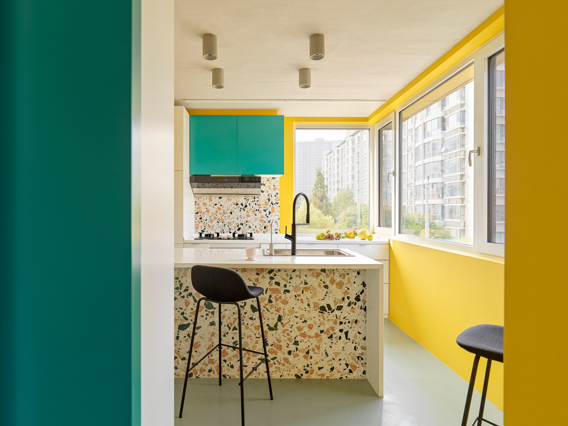 Yellow, teal and terrazzo kitchen