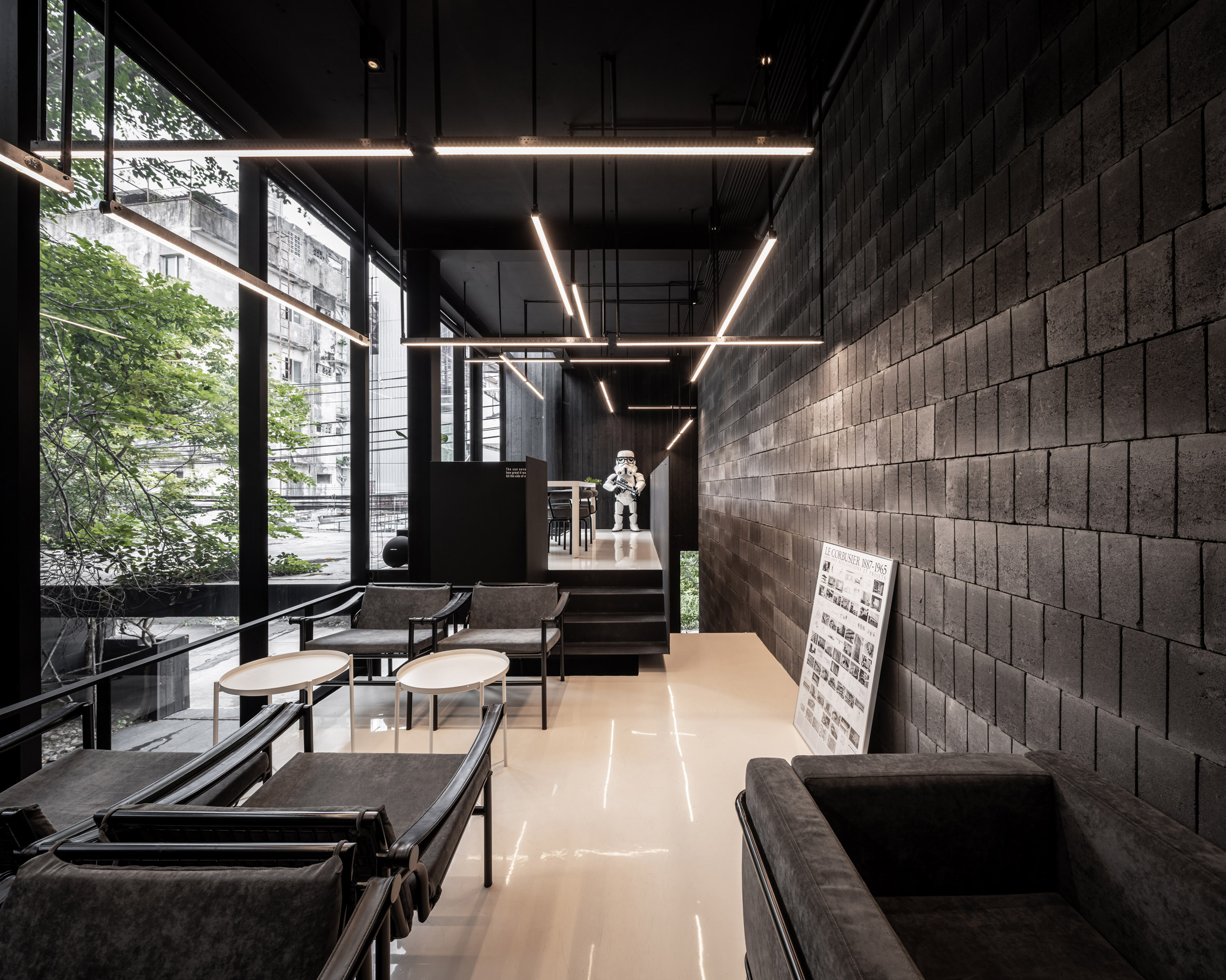 Black interiors of IDIN Architects Office in Bangkok, Thailand