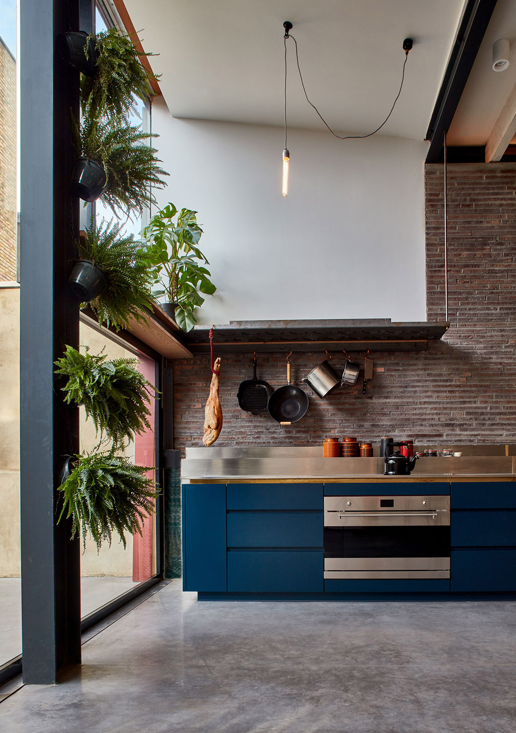 Exposed brick and steel kitchen extension