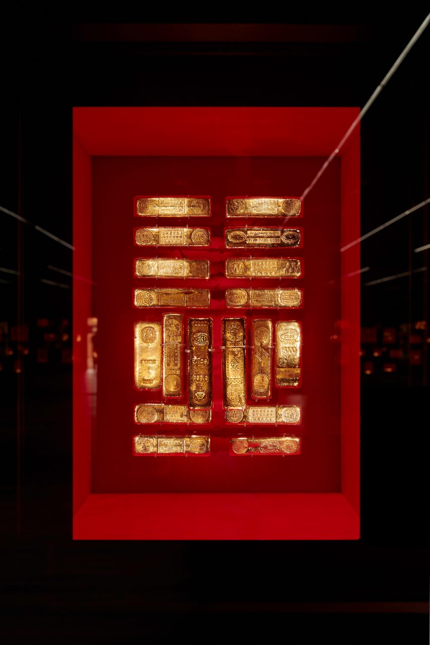Gold bullion against red silk The Rothschild Collection displayed by Pfarré Lighting Design at the Goldkammer Museum in Frankfurt