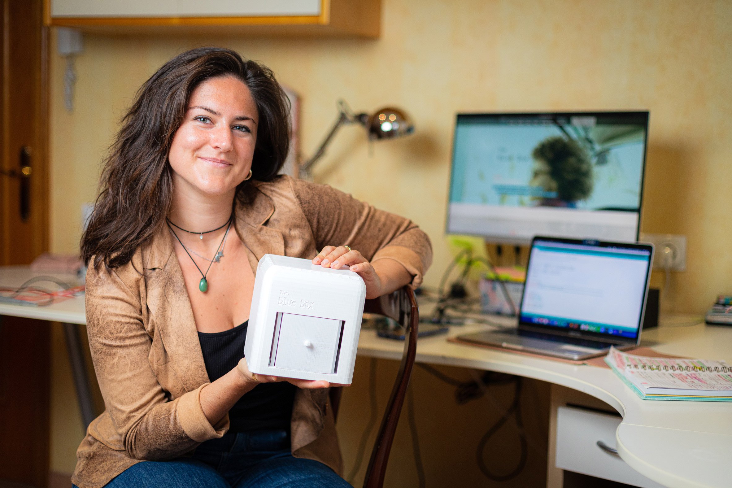 Judit Giró Benet holding The Blue Box, an at-home breast cancer testing kit