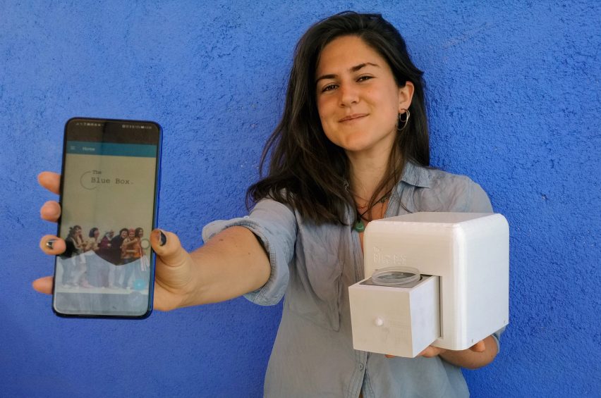 Judit Giró Benet holding The Blue Box, an at-home breast cancer testing kit