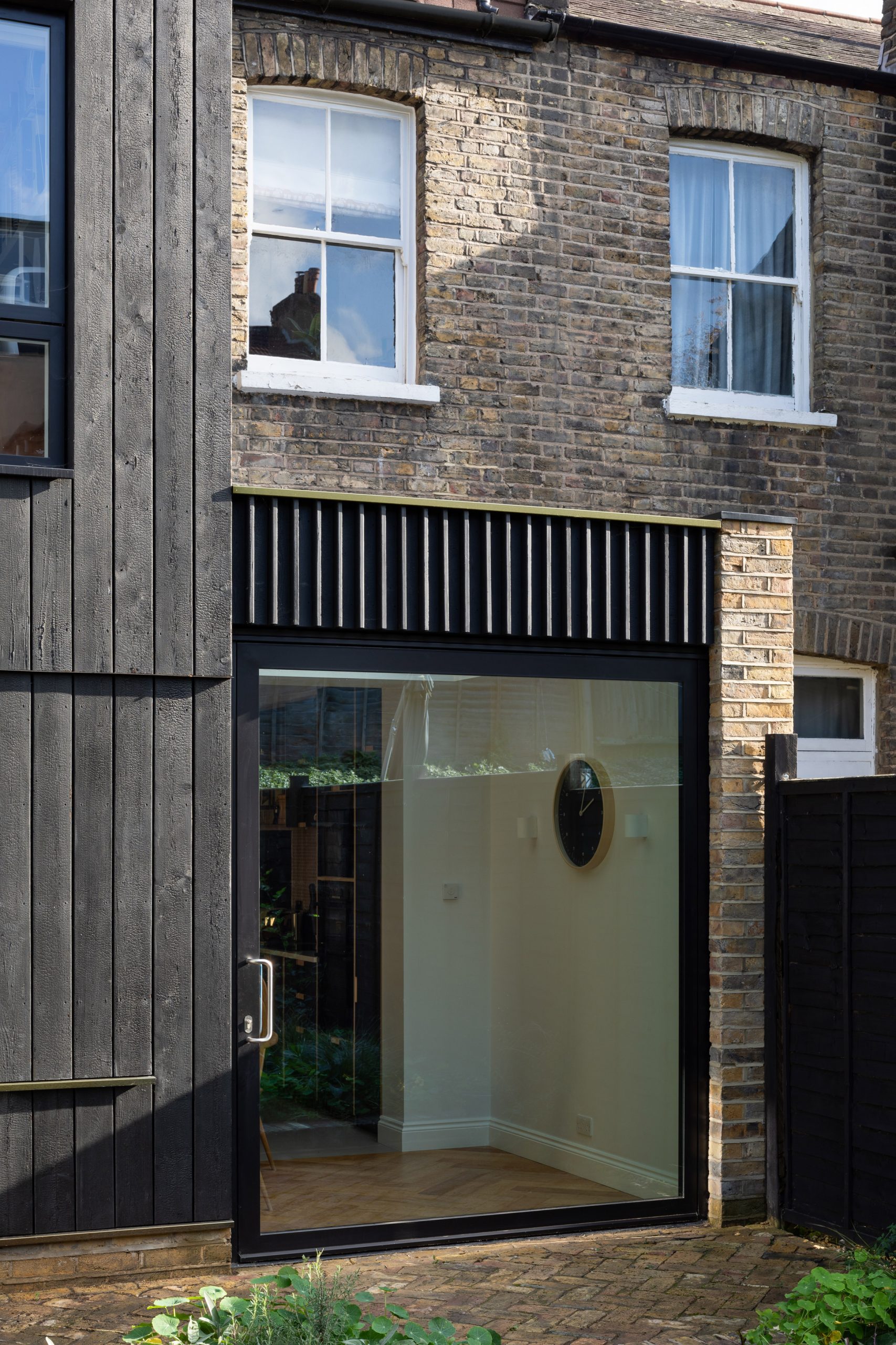 The pivot door of the Charred House extension by Rider Stirland Architects in London