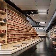 Library of law books wraps staircase in Mexico City office designed by Esrawe Studio