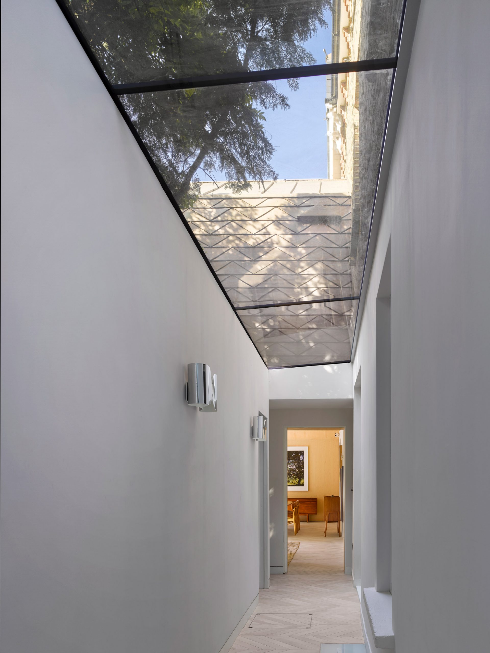 Glass-roofed garden passage in Hampstead House by Dominic McKenzie Architects
