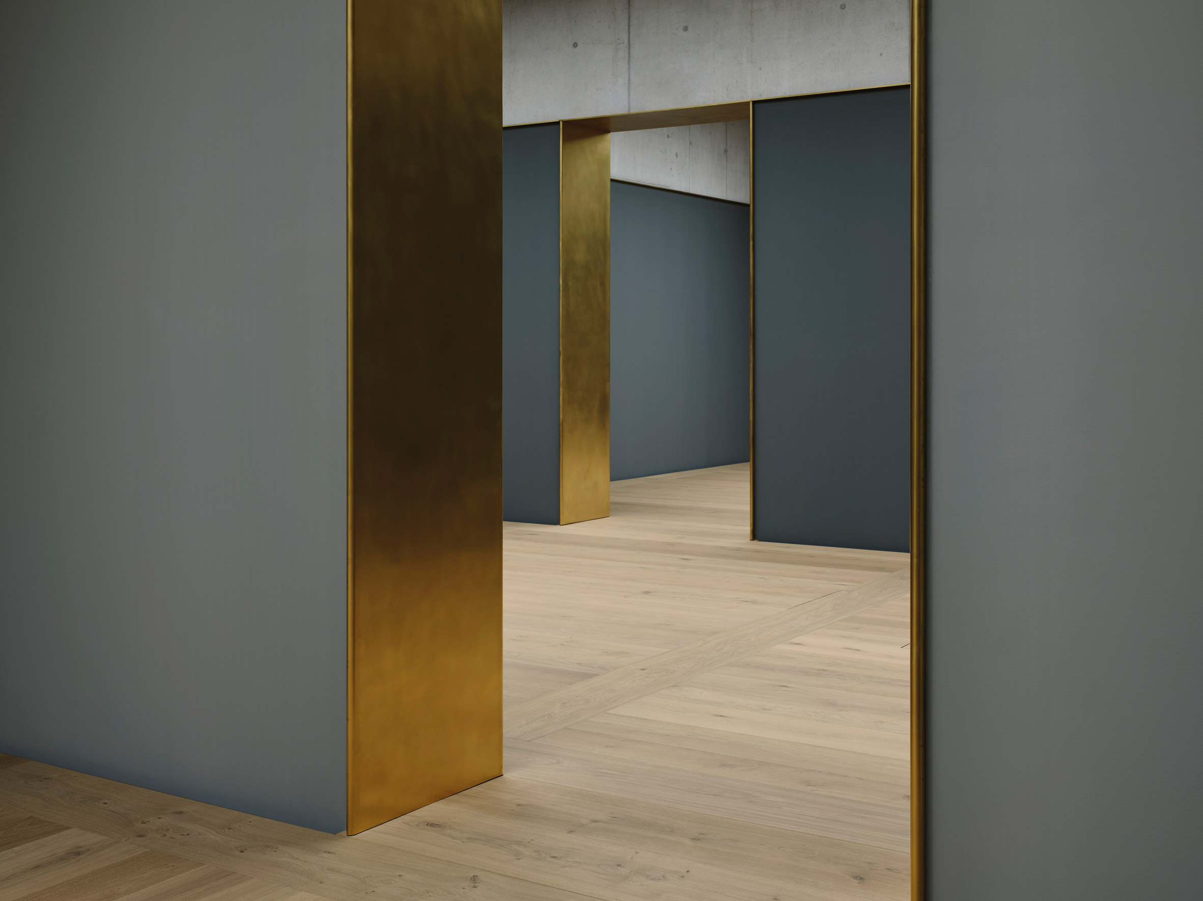 A grey-walled gallery inside of the Kunsthaus Zurich museum extension by David Chipperfield
