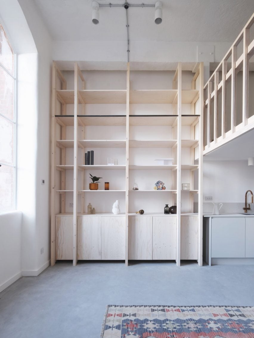 Double-height pine wood shelving unit from Bow Quarter interior by EBBA Architects