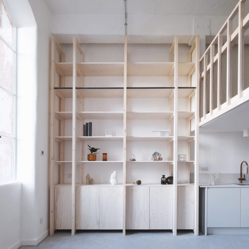 Double-height pine wood shelving unit from Bow Quarter interior by EBBA Architects