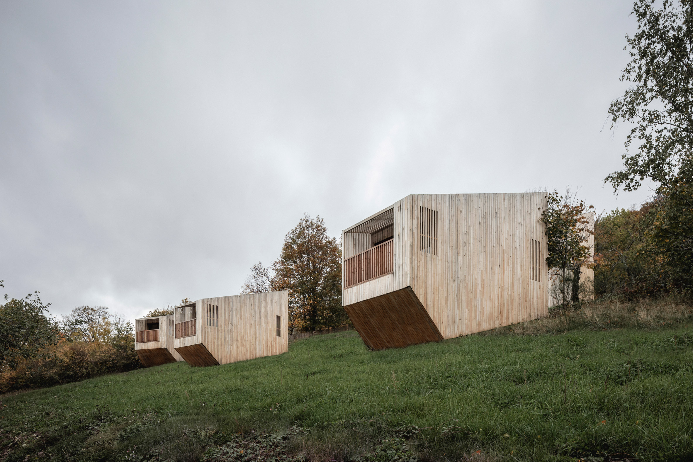 Wooden cabins scattered across grass