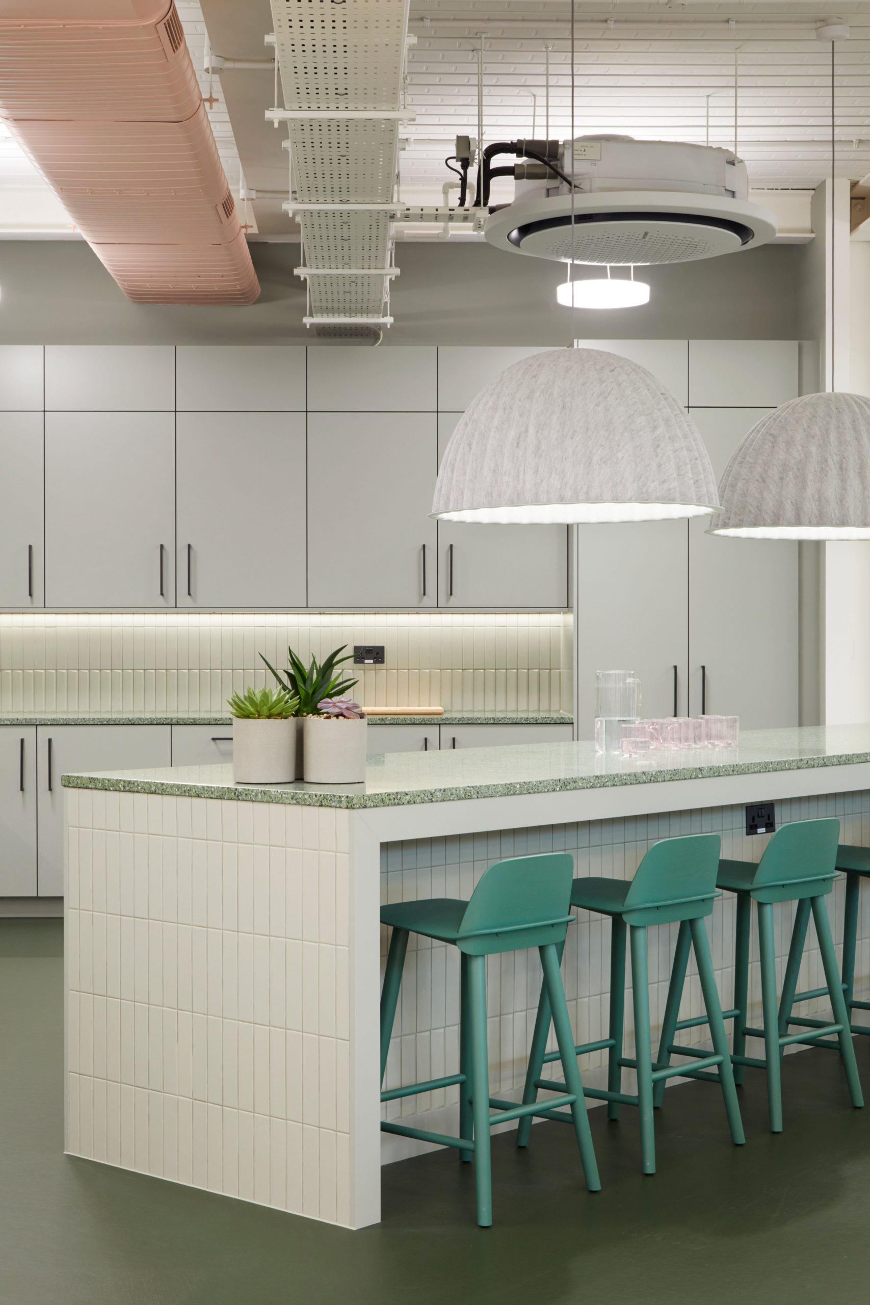Green stools in office kitchen