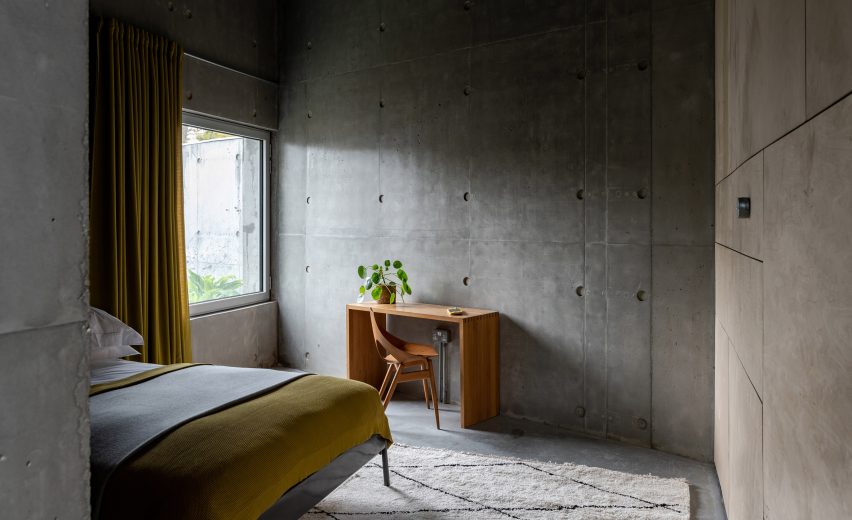 A bedroom inside Concrete House by RAW Architecture Workshop in East Sussex