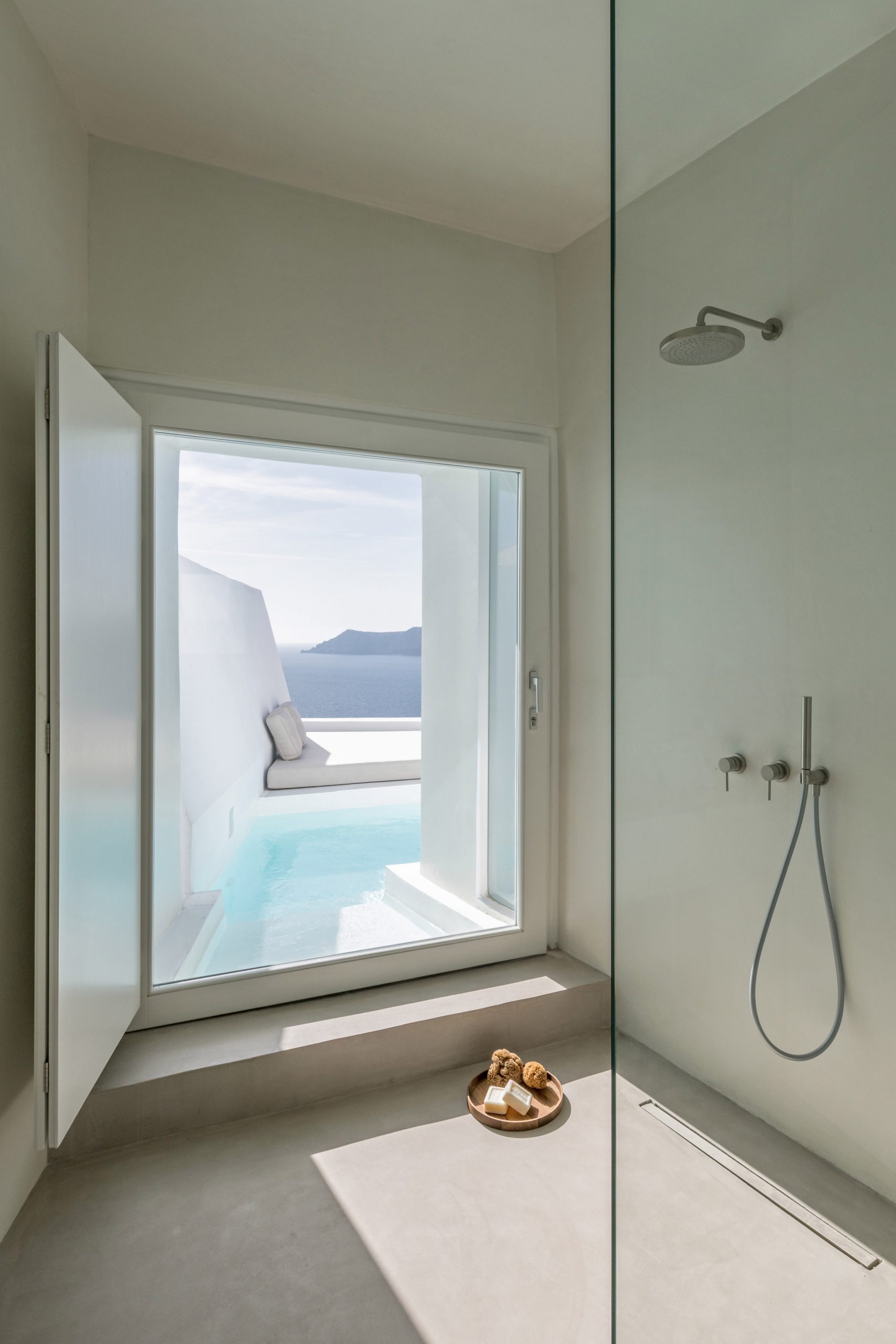 Minimalist hotel bathroom with view of the sea