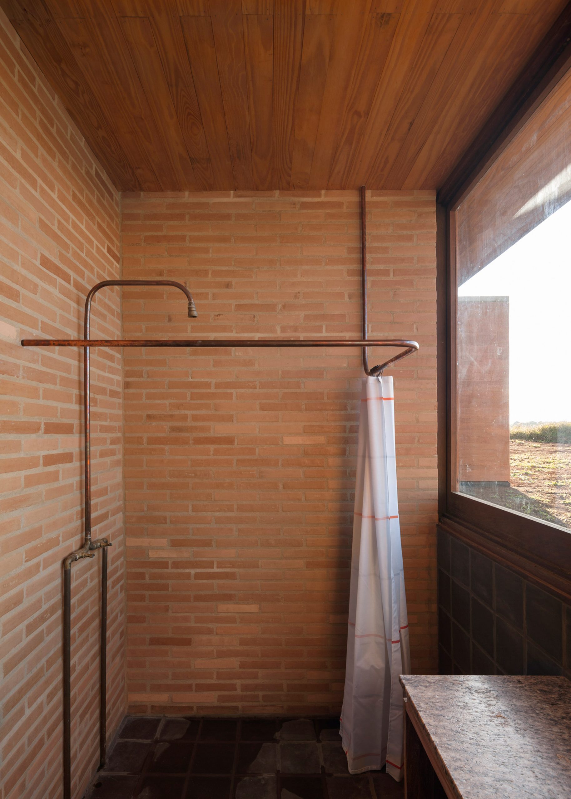 Brick-clad shower room with countryside view