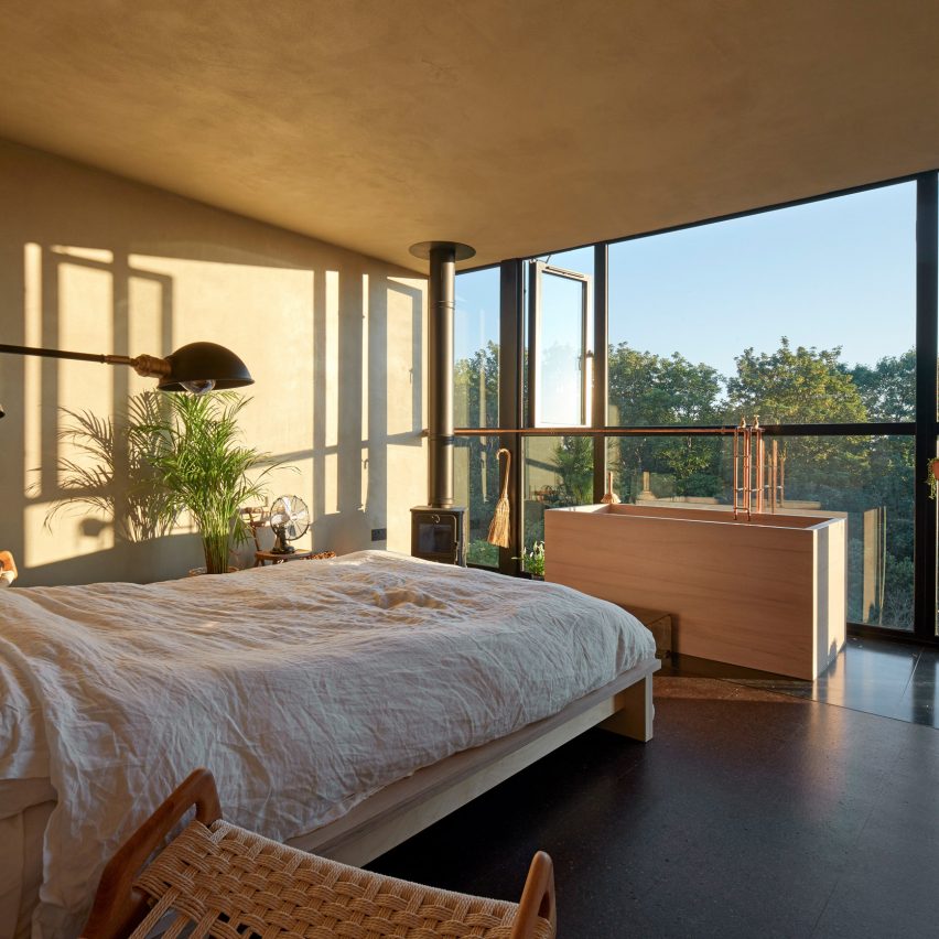 Bedroom with wooden bathtub with a view
