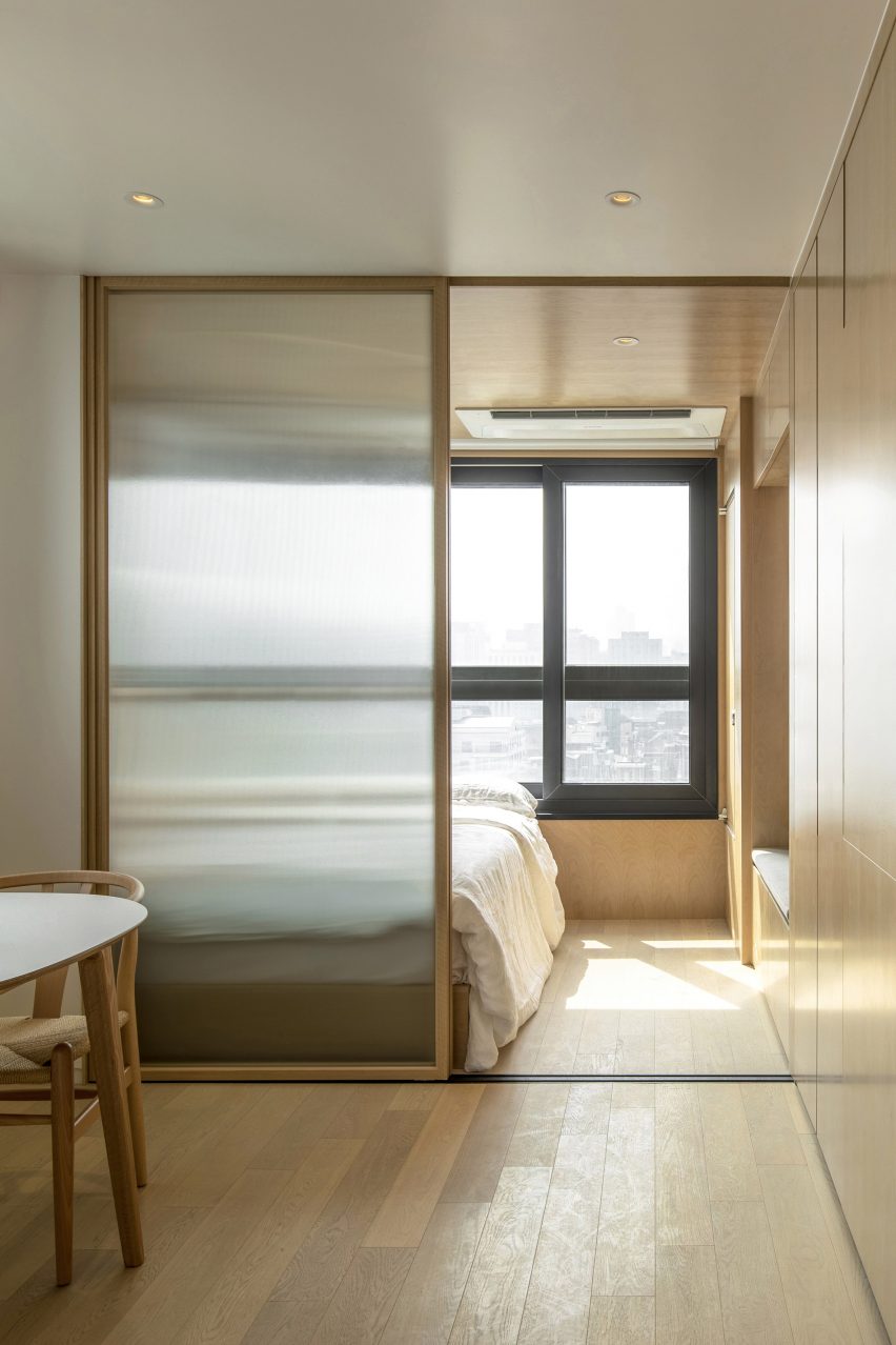 Wood-clad bedroom with interior window