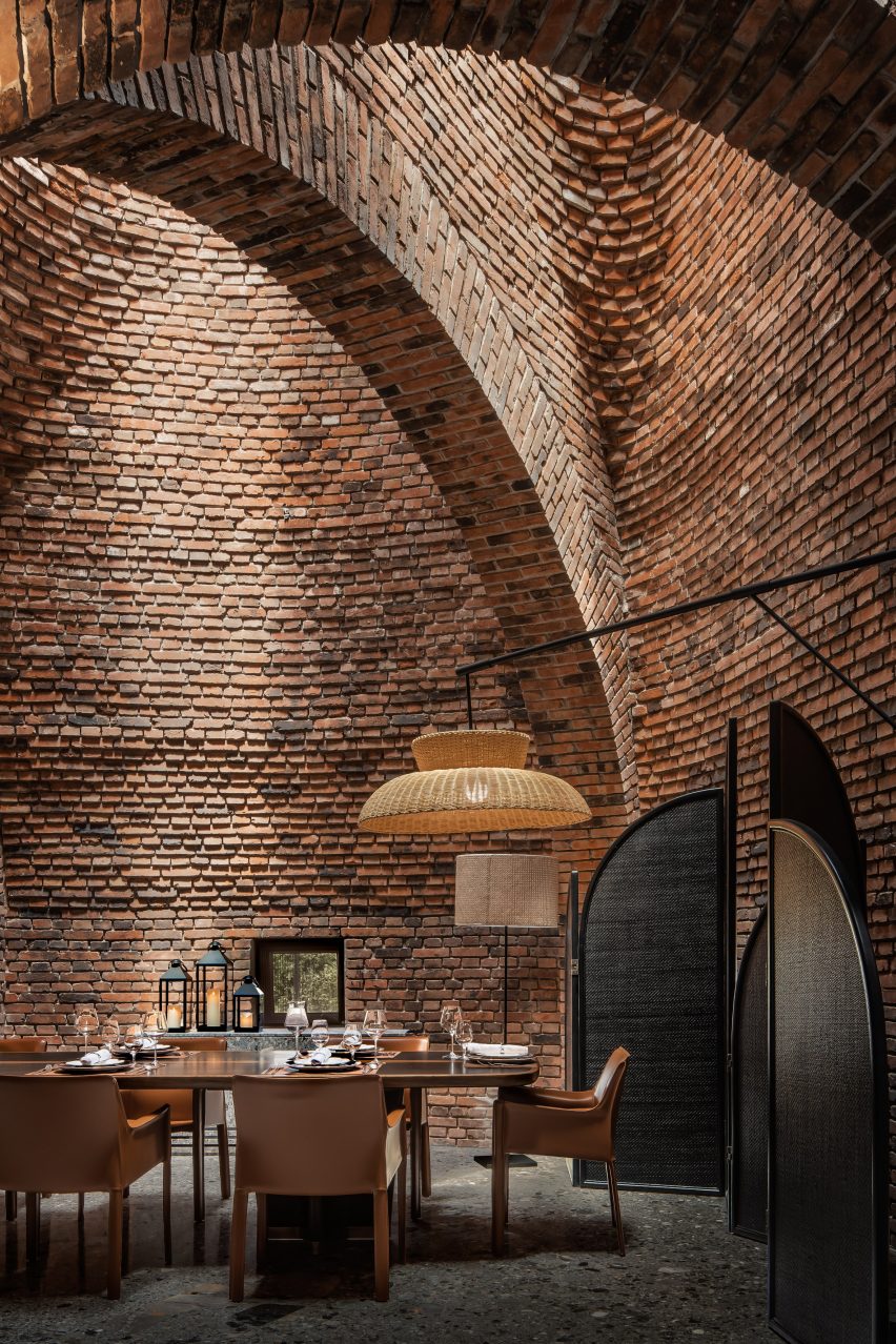 A restaurant with arched red-brick interiors