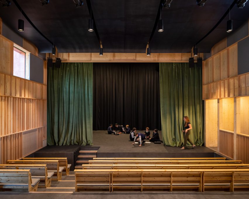 Theatre stage with green curtains by Jonathan Tuckey Design
