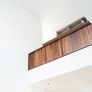 A walnut balustrade overlooks the living space