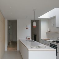 A white kitchen in a house extension in London by DeDraft