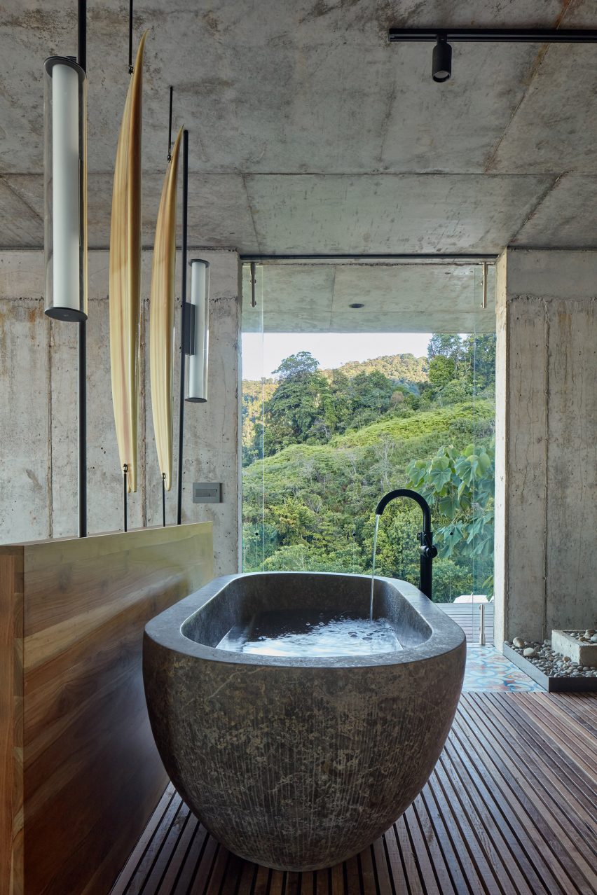 Concrete, freestanding bath with views of Costa Rican jungle