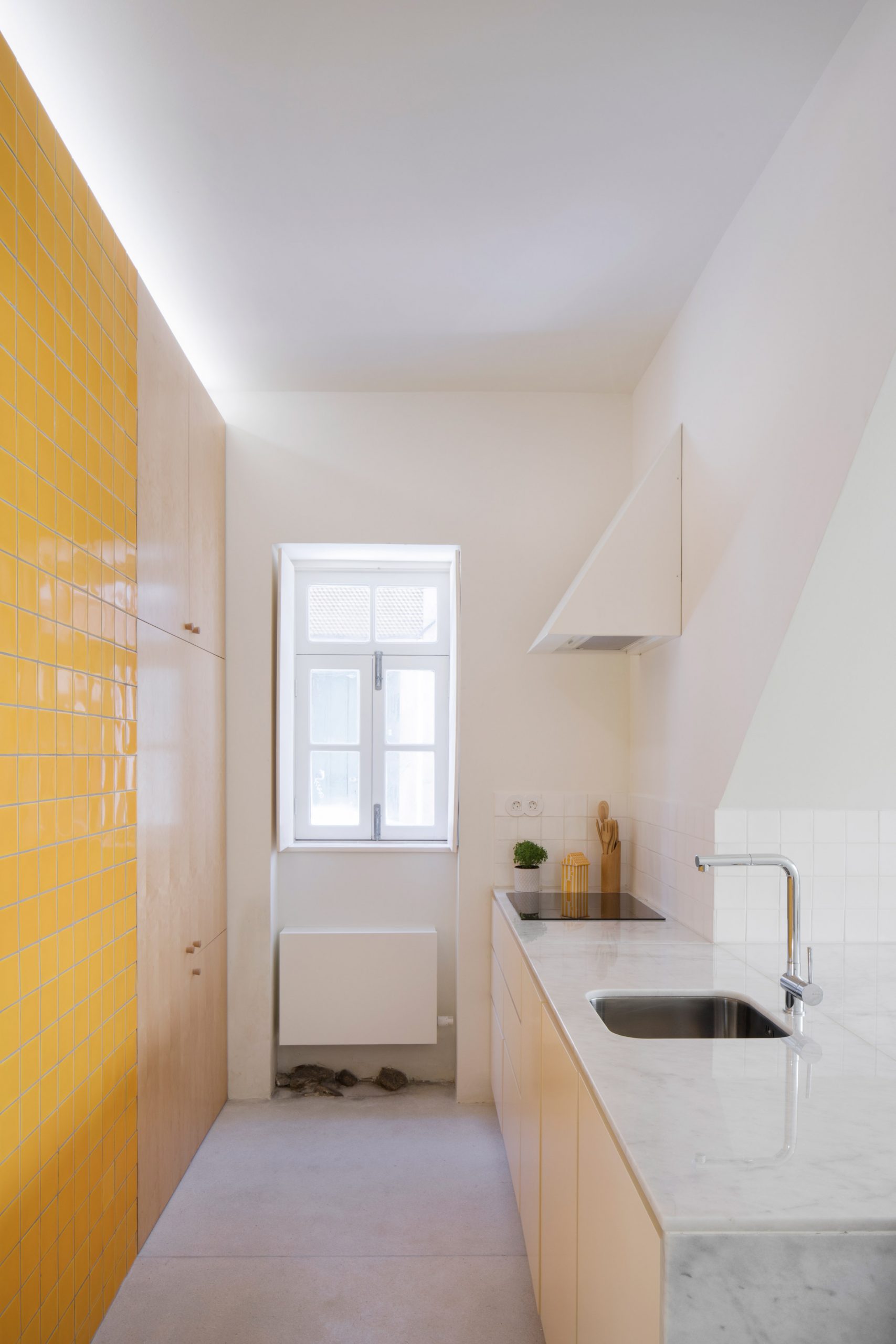 Downstairs kitchen with yellow tiles at Casa da Beiramar by Merooficina
