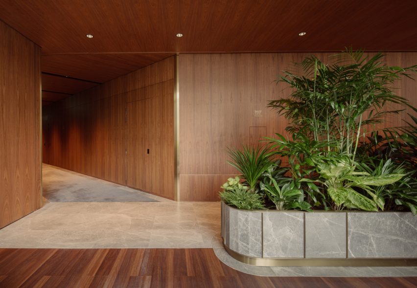 Marble planters and walnut wood walls on level eight of Citi Wealth Hub by Ministry of Design