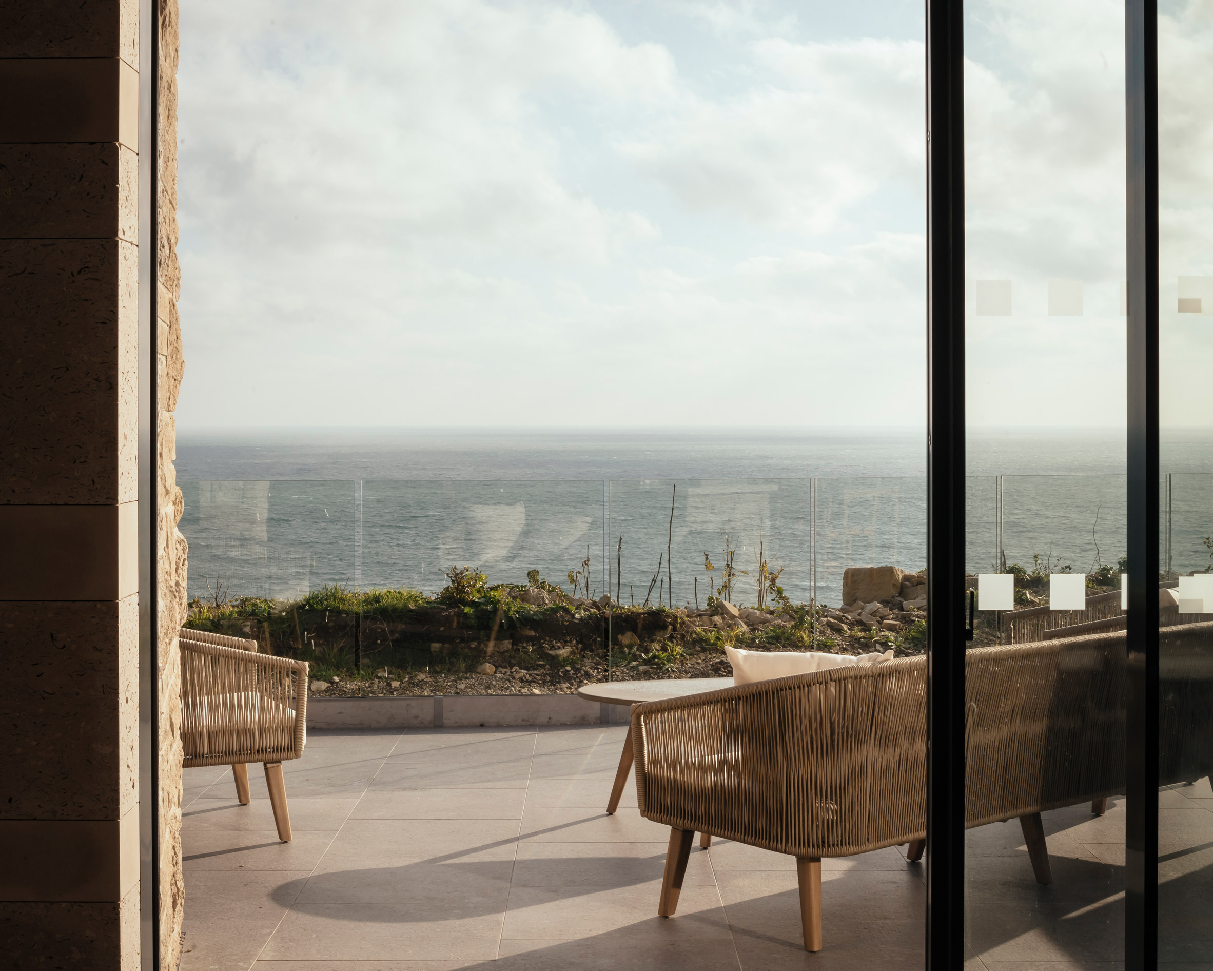Terrace with view across the sea by Morrow + Lorraine