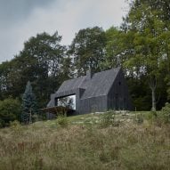 Mjölk Architekti updates Czech cottage with burnt-wood cladding and revamped interior