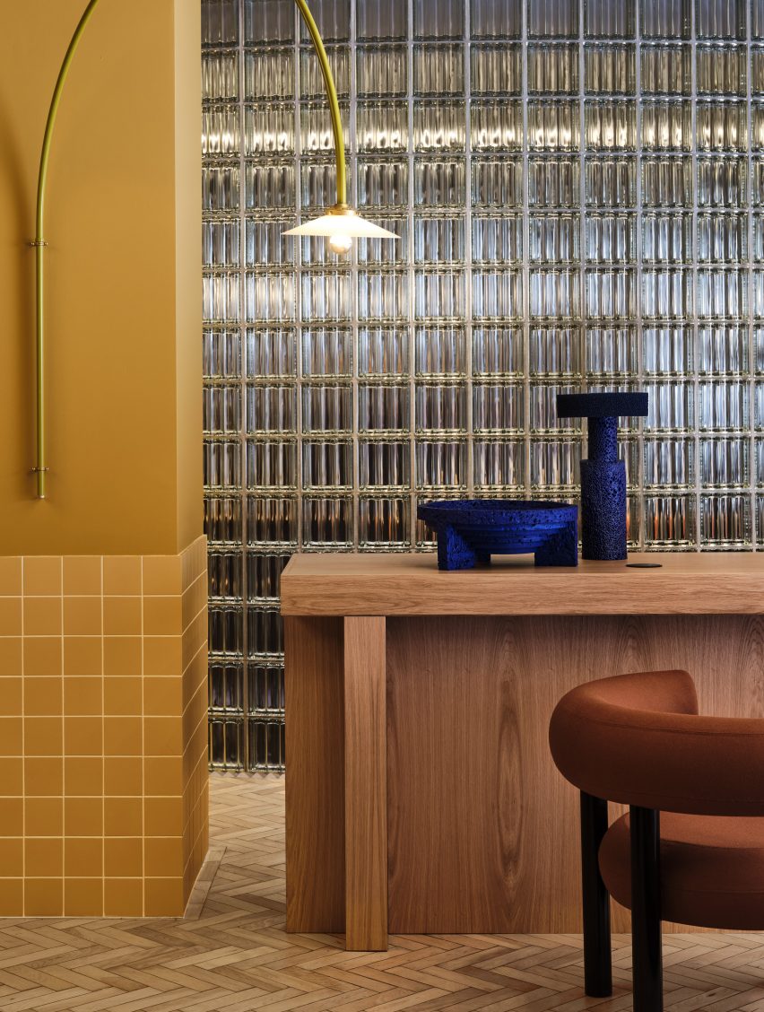Glass block wall and yellow ceramic tiles in Douglas House