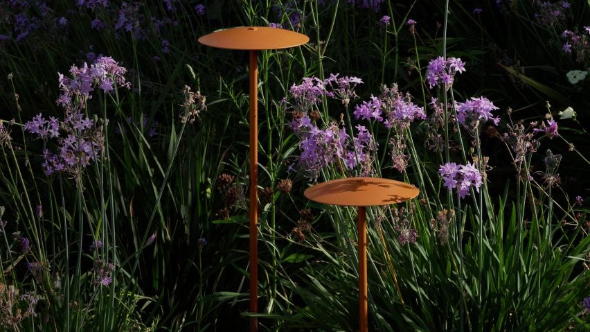 Two outdoor lamps by Marset hidden within greenery